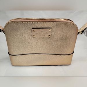 Kate spade crossbody gold shell with pink liner.